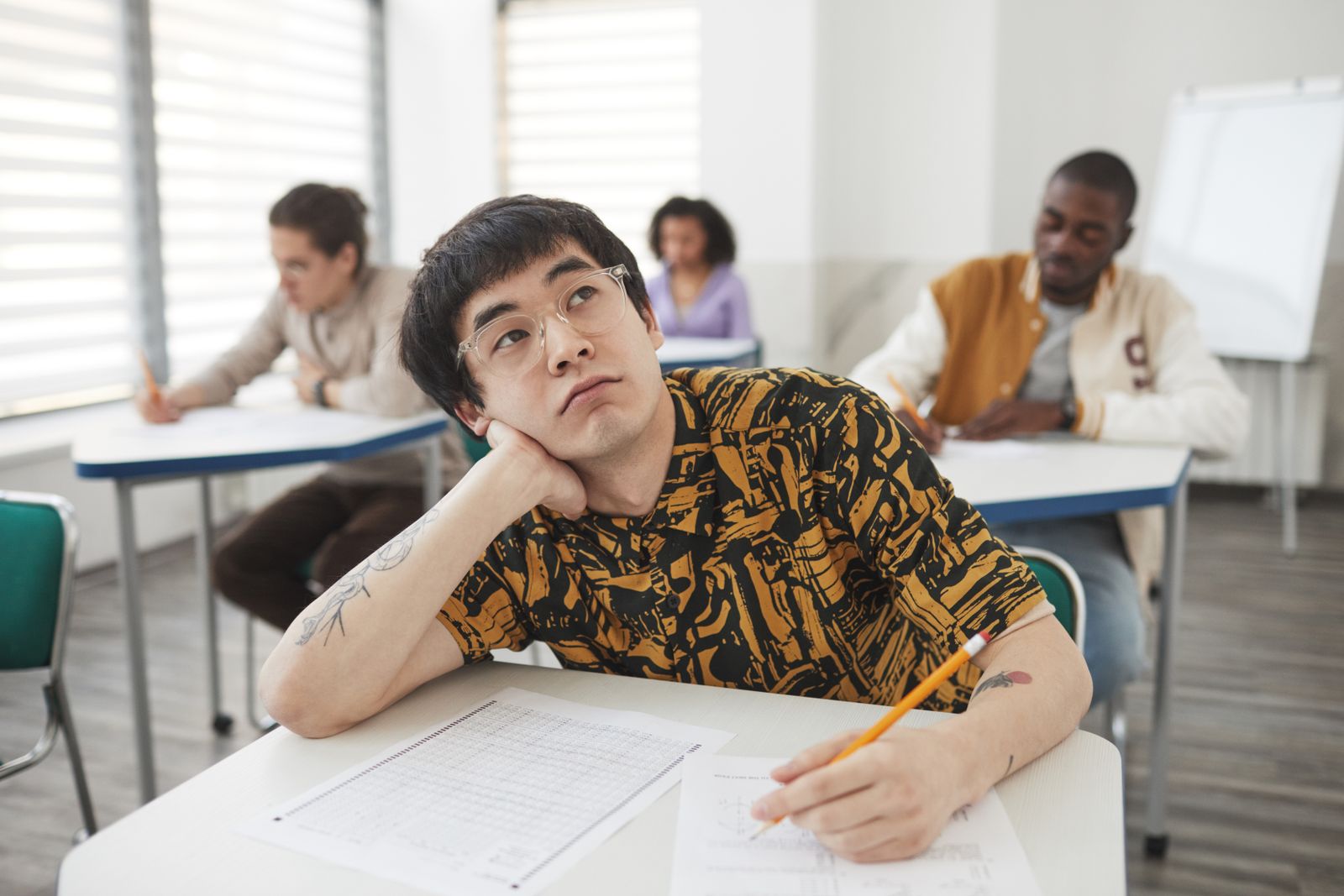 Adult candidate taking a written language exam with pencil and answer sheet